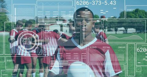 Youth soccer player holding ball with augmented hud display showing performance data