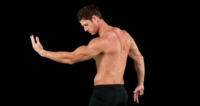 Side view of caucasian strong man flexing muscles with copy space on black background. Boxing, strength, fitness concept.