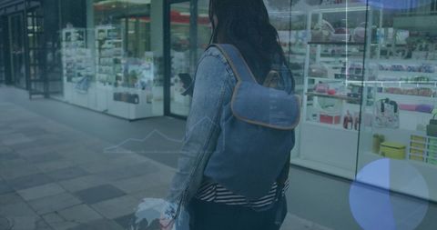 Woman Engaged with Technology on Modern Street