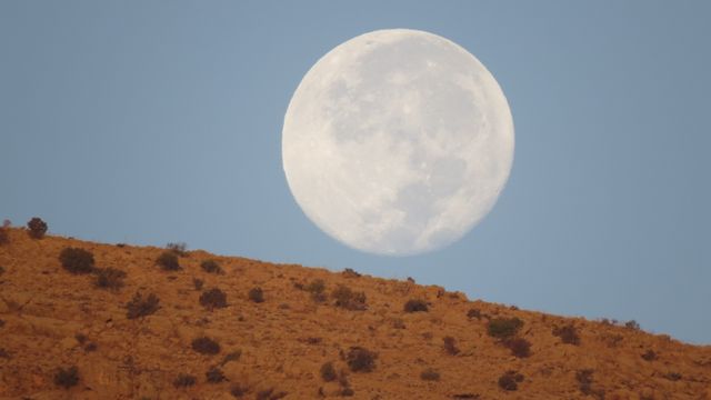 Full Moon Rising Over Desert Landscape at Dusk - Download Free Stock Photos Pikwizard.com