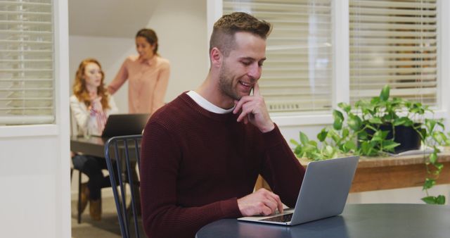 Young Professional Man Working on Laptop in Modern Office Environment - Download Free Stock Images Pikwizard.com