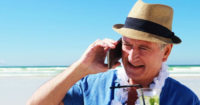 Senior Man Enjoying Beach Vacation While on Phone Call - Download Free Stock Images Pikwizard.com