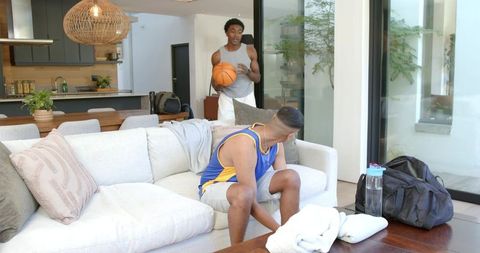 Friends Relaxing Indoors with Basketball in Stylish Living Room
