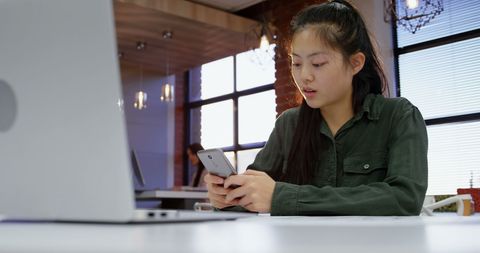 Asian Businesswoman Engaged in Mobile Work in Modern Office - Download Free Stock Images Pikwizard.com