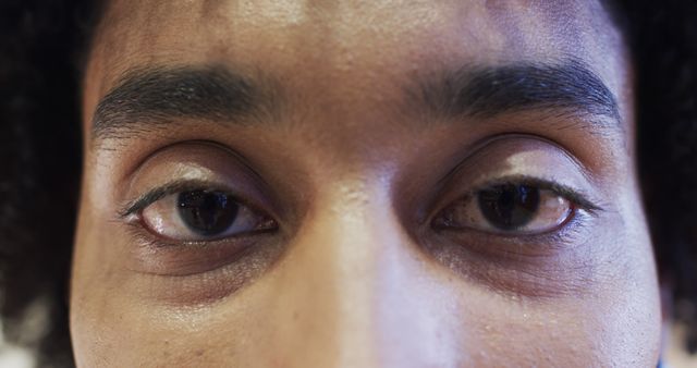 Portrait of eyes of biracial male basketball player on indoor court. Sport, fitness, health and team sport, unaltered.