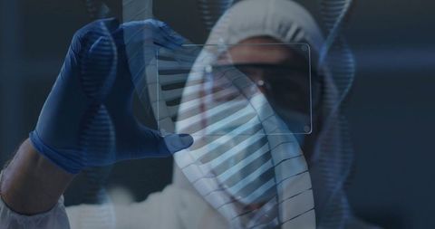 Scientist in protective gear analyzing dna sample in laboratory