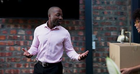 Coworkers welcoming new team member in casual office environment