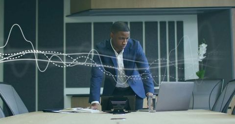 Businessman analyzing digital data in modern boardroom