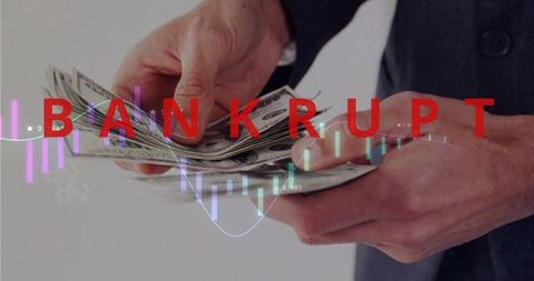 Businessman counting cash while bankrupt warning and falling stock chart overlay