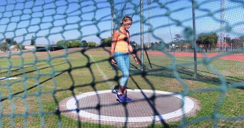 Female Athlete Preparing for Discus Throw on Field - Download Free Stock Images Pikwizard.com