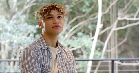 Young Man Contemplating Scenic View Through Large Windows