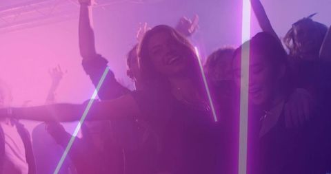 Friends dancing under pink lasers in crowded nightclub, neon nightlife energy