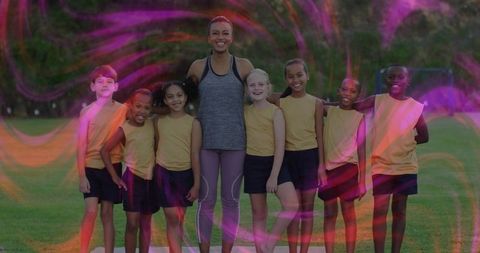 Diverse youth soccer team with coach in vibrant outdoor setting