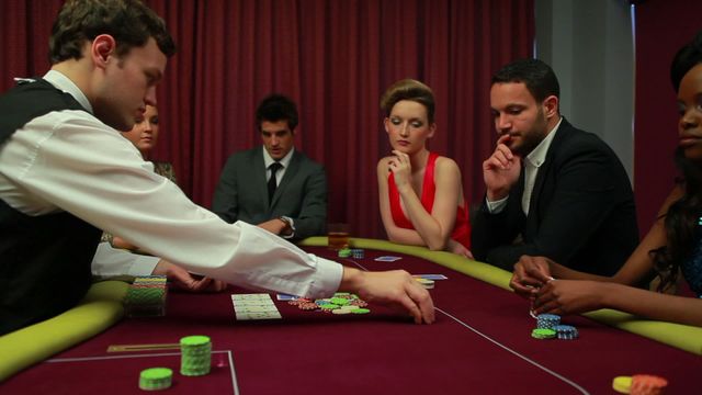 Group of people participating in a poker game with focus and concentration. Appealing for materials on gambling, casino atmospheres, professional poker playing. The intensity and focus suitable for illustrating intense gaming narratives or promotional content for events related to card games and gambling entertainment.