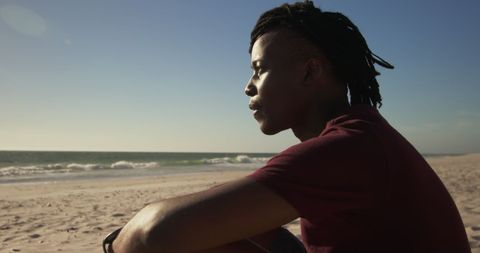Contemplative Man Relaxing on Sunny Beach - Download Free Stock Images Pikwizard.com