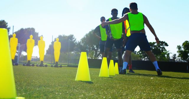 Football Players Practicing with Bright Markers on Field - Download Free Stock Images Pikwizard.com