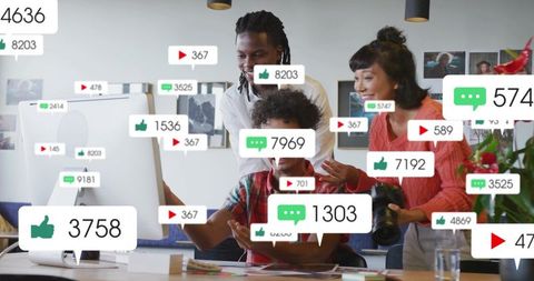 Creative team reviewing social media engagement and content metrics at desk with camera
