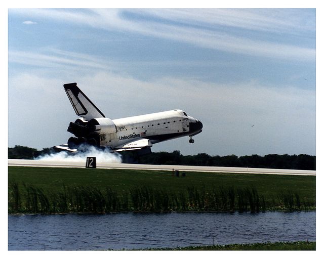 This image captures the Space Shuttle Columbia during its touchdown on Runway 33 at Kennedy Space Center, concluding the STS-83 mission on April 8, 1997. The photo is perfect for articles and educational materials on space exploration, NASA missions, space history, and aerospace technology. It can also be used in presentations focused on the history and advancement of space missions and shuttles.
