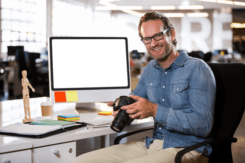 man holding digital camera at office desk in transparent workspace - Download Free Stock Videos Pikwizard.com