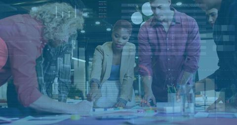 Team Analyzing Blueprints with Digital Interfaces in Office