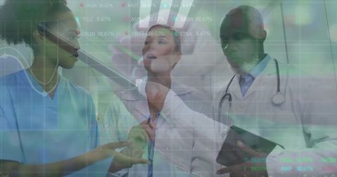 Medical Team Analyzing Digital Charts on Tablet