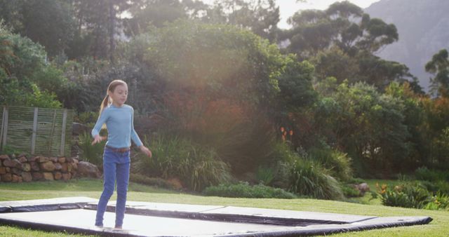 Young Girl Bouncing on Trampoline in Scenic Backyard - Download Free Stock Images Pikwizard.com