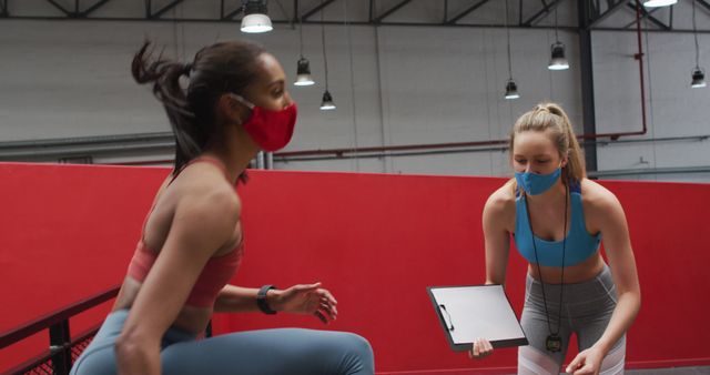 Women Exercising and Coaching in Indoor Gym While Wearing Face Masks - Download Free Stock Images Pikwizard.com