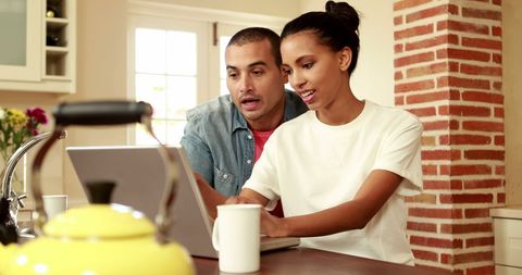 People Collaborating on Project in Kitchen Together