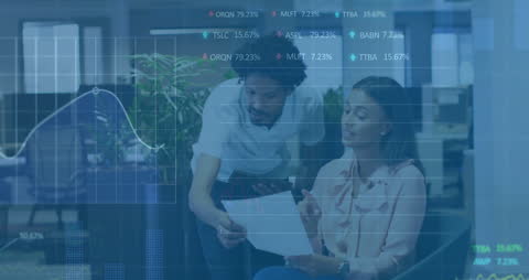 Coworkers Analyzing Stock Market Data in Office