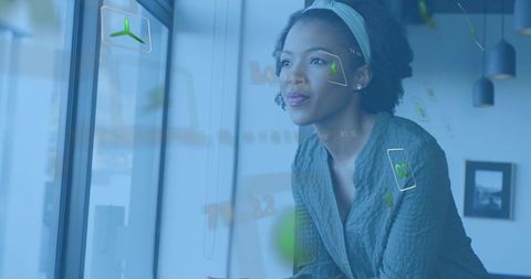 Businesswoman leaning by window visualizing holographic ui for urban workplace innovation