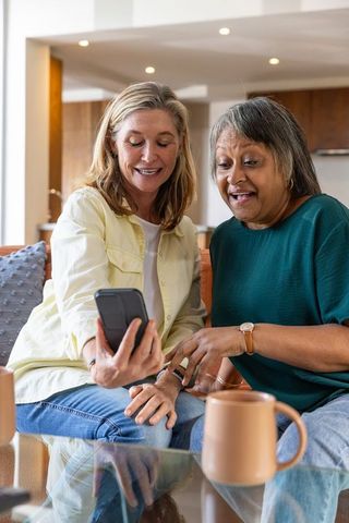 Senior Friends Enjoying Relaxed Moments Sharing Smartphone Photos