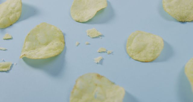 Close up of potato chips with copy space on blue surface - Download Free Stock Photos Pikwizard.com