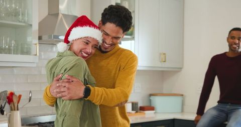Joyful Couple Embracing at Modern Christmas Kitchen Gathering