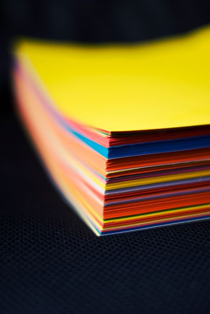 Close-up of Colorful Stacked Papers with Black Background - Download Free Stock Photos Pikwizard.com