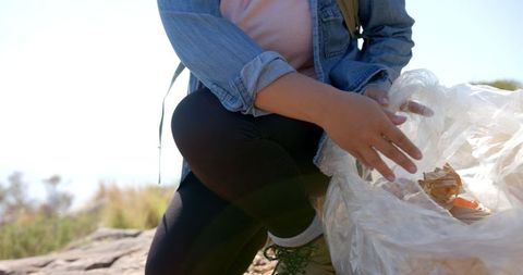 Hiker Collecting Litter on Mountain Trail for Environmental Cleanup