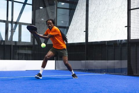 Dynamic Paddle Action on Modern Blue Padel Court