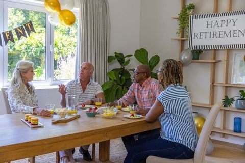 Diverse Friends Celebrating Retirement Gathering at Home