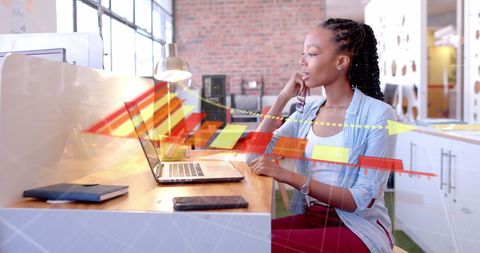 Focused Businesswoman Analyzing Data with Diagram Overlay