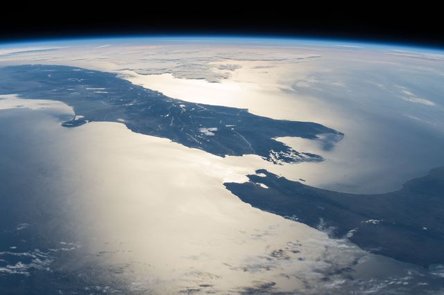 Beautiful high-resolution photograph taken from space shows stunning views of Earth's land and water bodies. Perfect for use in educational materials, environmental projects, geography lessons, background imagery for space and science topics, and promoting global awareness and appreciation of our planet's natural beauty. Ideal for illustrating Earth’s diverse landscapes in an inspirational or scientific context.