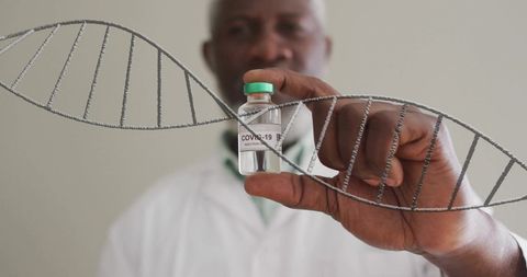Doctor Holding Vaccine Vial with DNA Strand Symbolizing Scientific Innovation