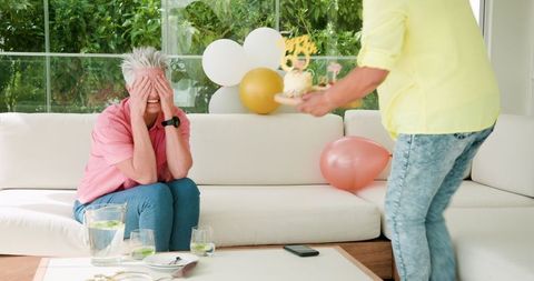 Senior Couple Celebrating Birthday with Joy and Surprise