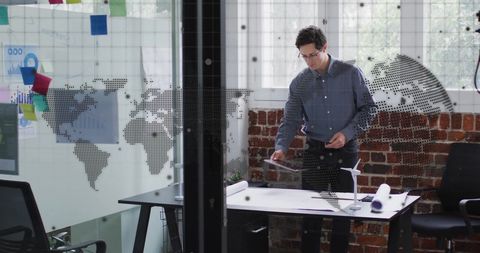 Businessman Utilizing Tablet with Digital Data Overlay in Office