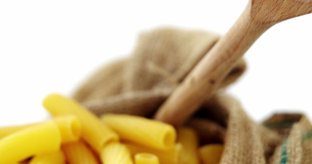 Close-Up of Raw Pasta in Burlap Sack with Wooden Spoon - Download Free Stock Images Pikwizard.com