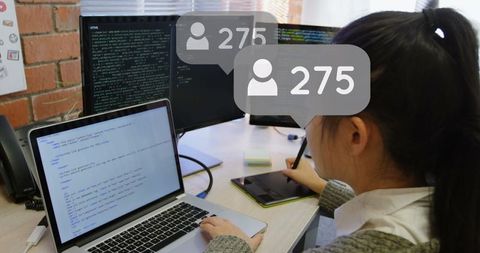 Woman Engaging with Social Media on Desk with Computers