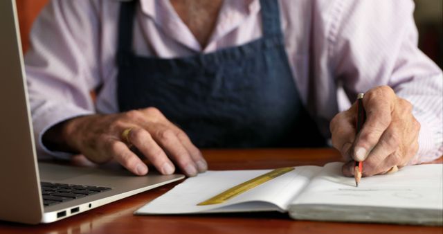 Senior Man Working on Project With Laptop and Notebook - Download Free Stock Images Pikwizard.com