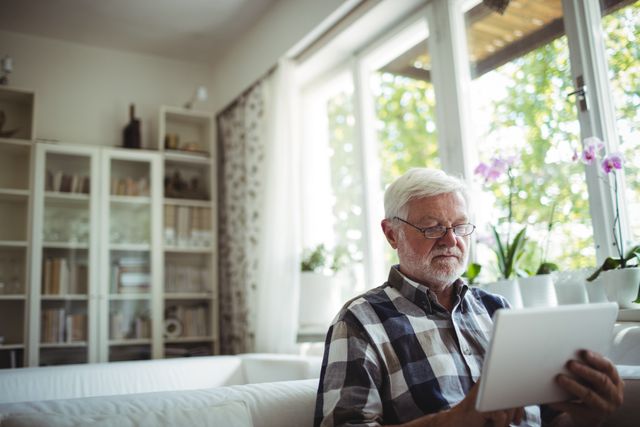 Senior Man Using Digital Tablet at Home - Download Free Stock Photos Pikwizard.com