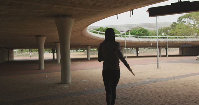 Woman Jogging Under Modern Urban Bridge in City Park - Download Free Stock Images Pikwizard.com