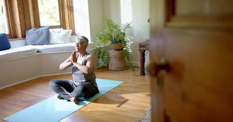 Senior Woman Meditating at Home for Mindfulness and Relaxation