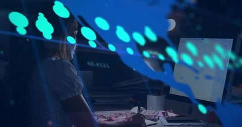 Woman working late at digital workstation with teal data overlay and creative tools