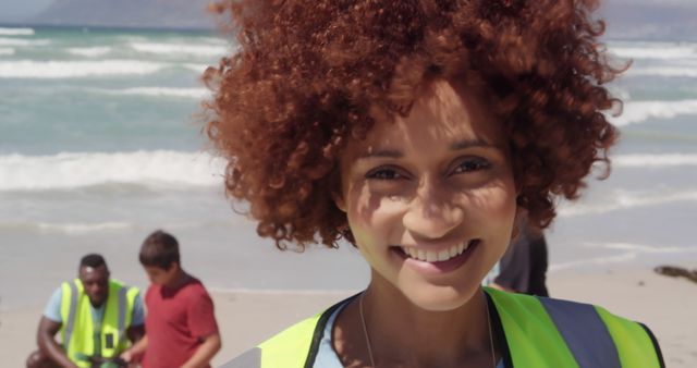 Smiling Volunteer at Beach Cleanup Event with Ocean in Background - Download Free Stock Images Pikwizard.com